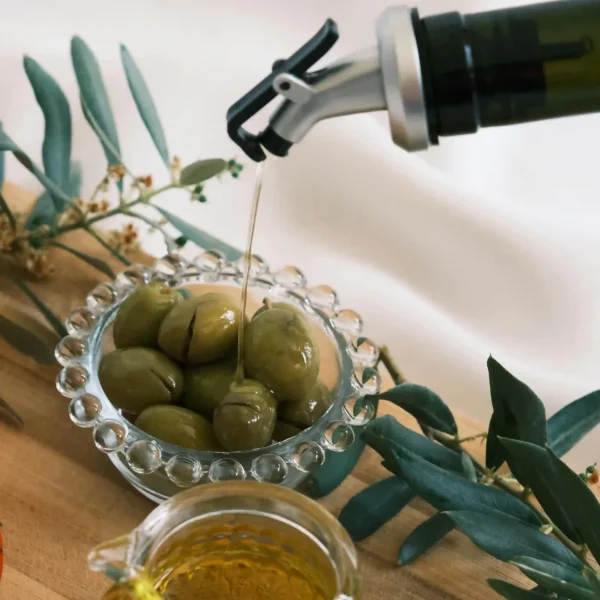 pouring extra virgin olive oil into glass bottle fresh natural olive oil preparation