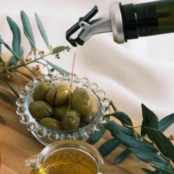 pouring extra virgin olive oil into glass bottle fresh natural olive oil preparation